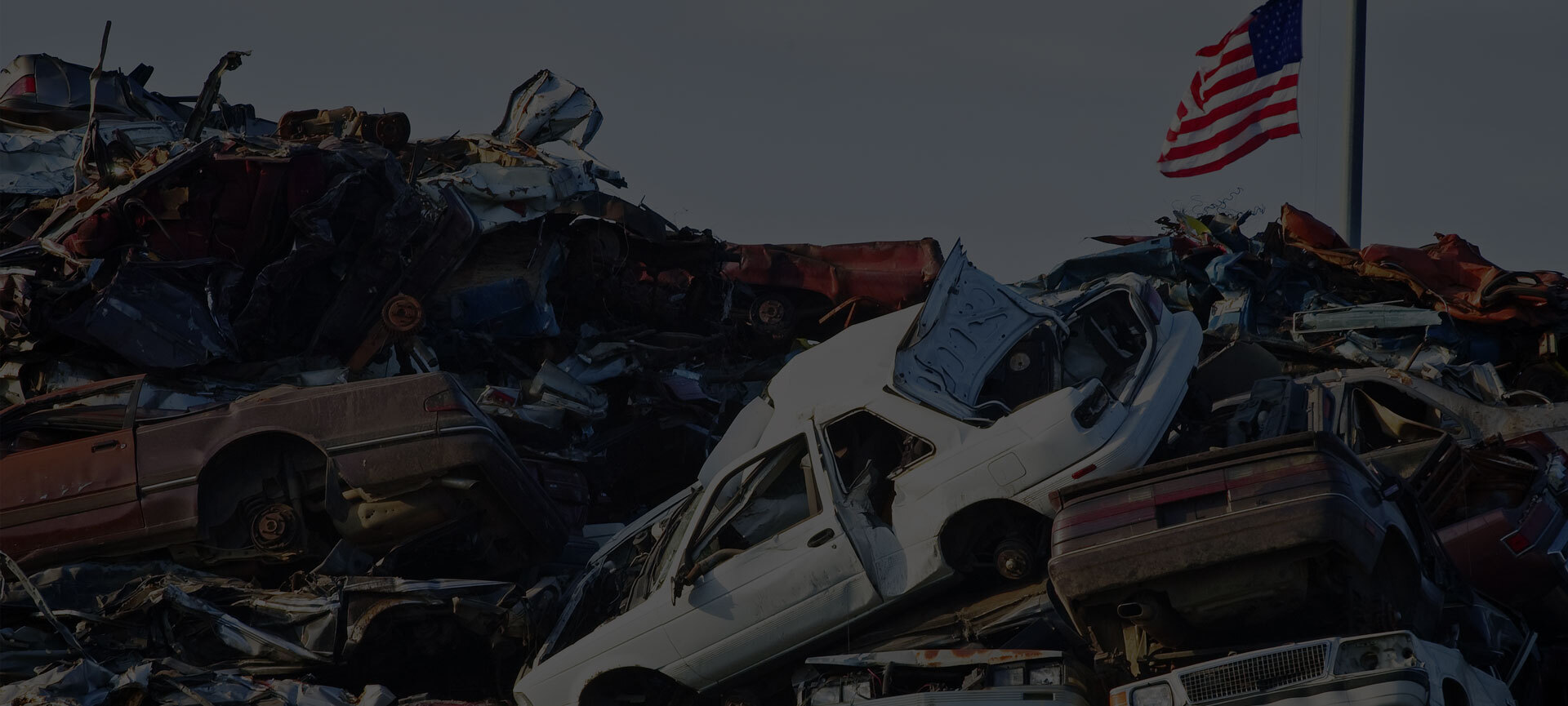 Rows of end-of-life vehicles at an auto recycling yard