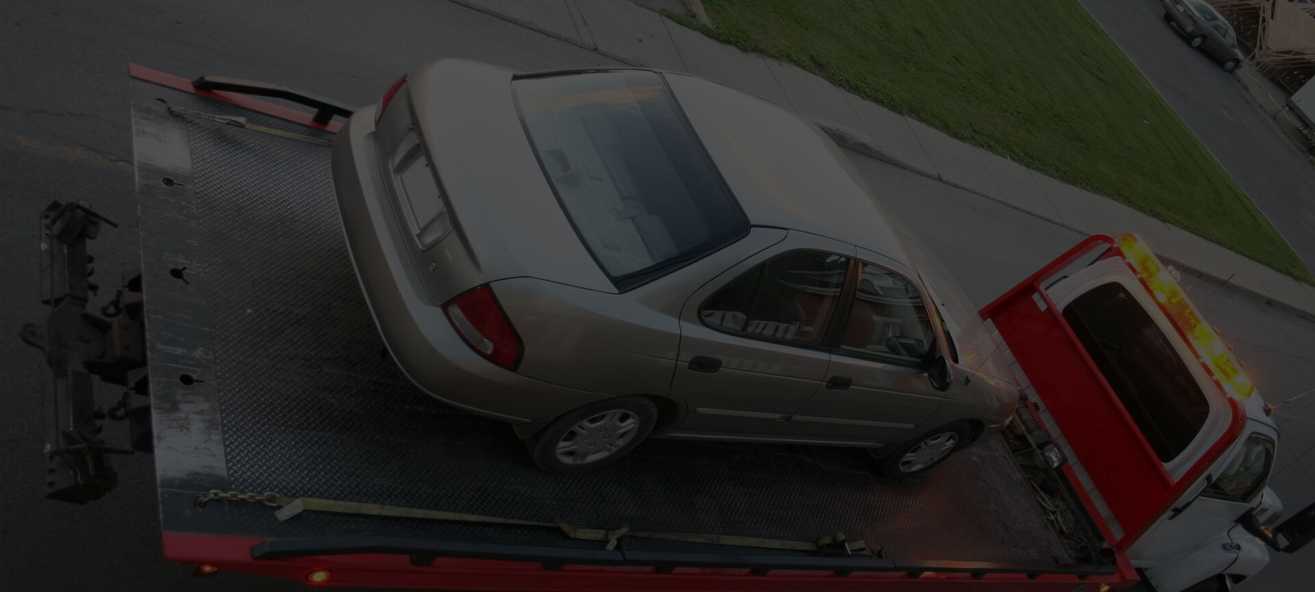 A vehicle secured on a flatbed tow truck